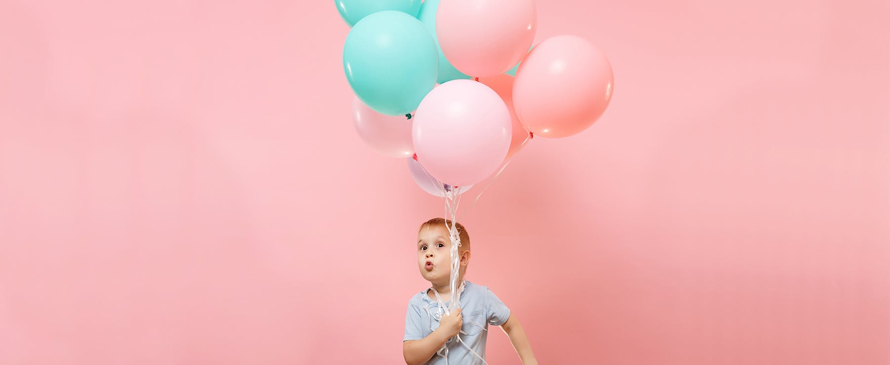 boy with pink and blue balloons