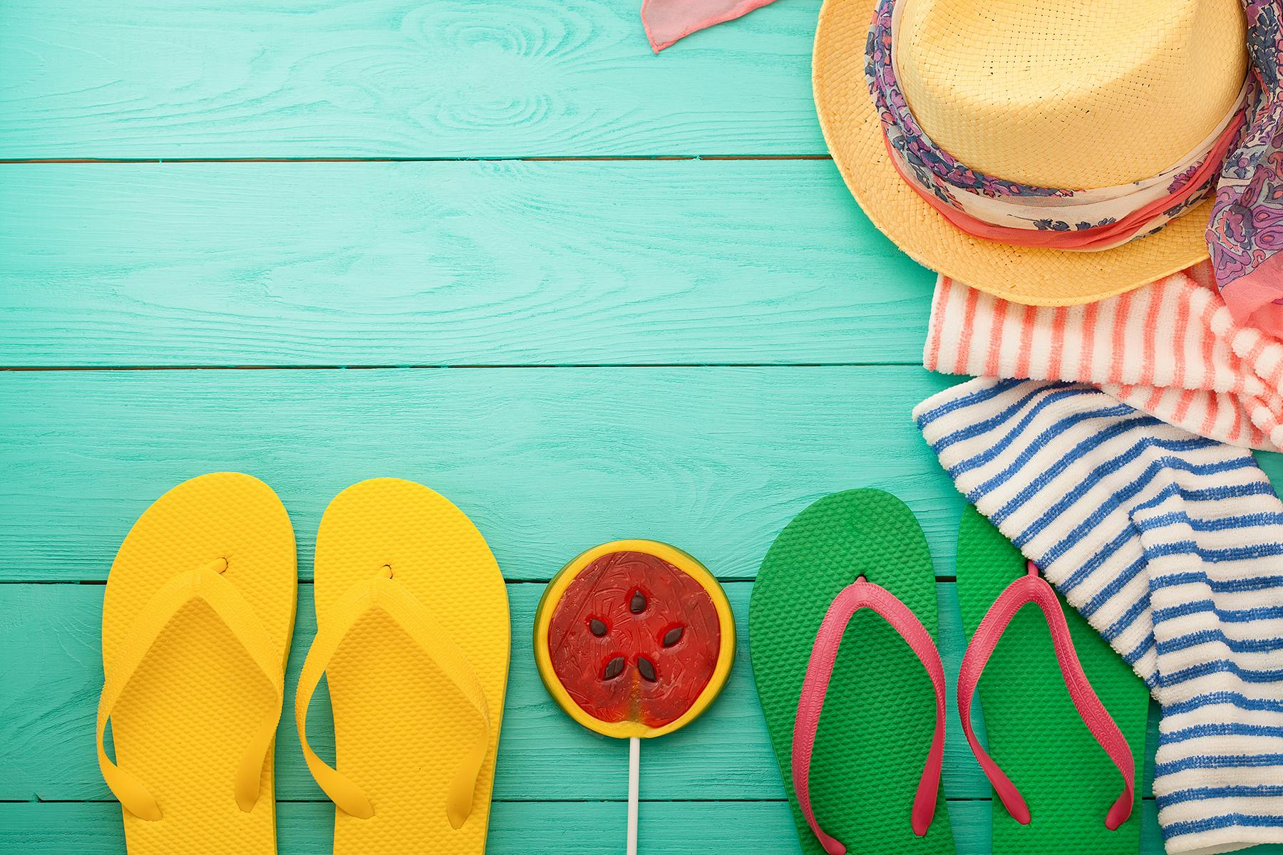 yellow and green flip flops on a blue background
